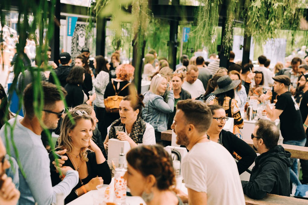 A group of people drinking in a beer garden.